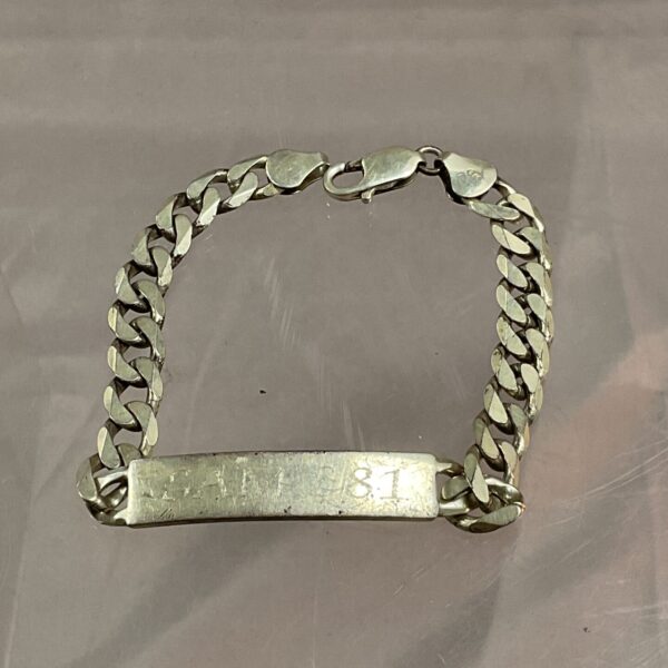 Vintage silver identity bracelet with curb chain design.