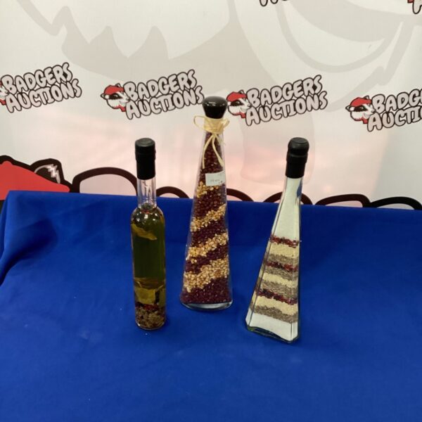 Vintage glass kitchen display bottles with colourful contents.