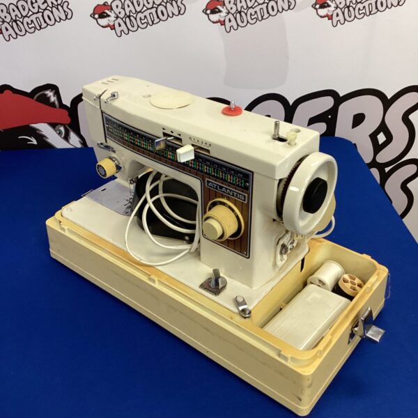 Front view of a vintage Atlantis electric sewing machine.