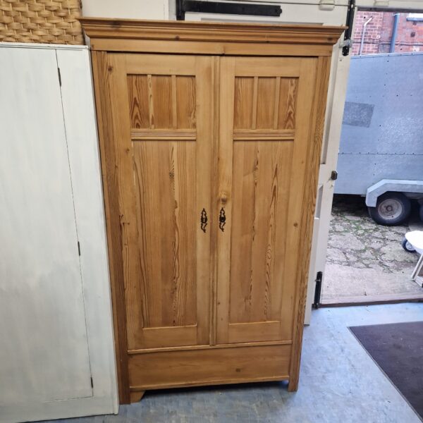 Large vintage pine wardrobe with classic design.