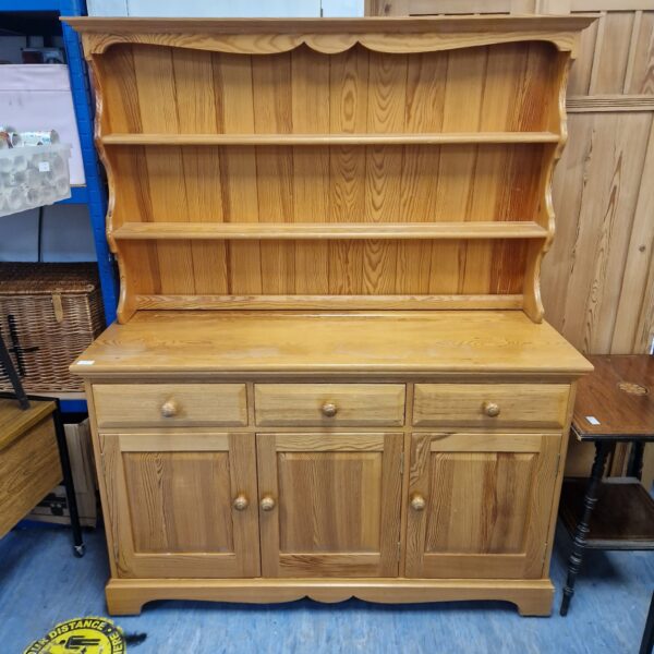 Vintage pine Welsh dresser with open shelves and cupboards.