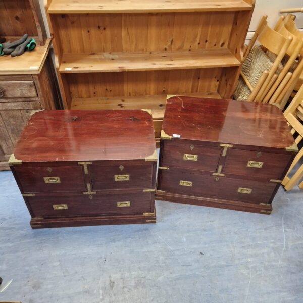 Antique wooden drawers with brass handles and detailing for storage.