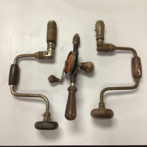 Vintage brace drill set with wooden handles and metal frames.