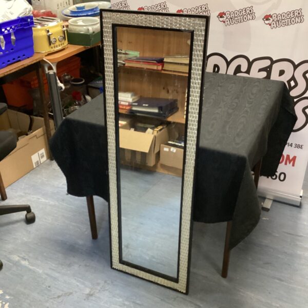Art Deco framed mirror displayed on a table.