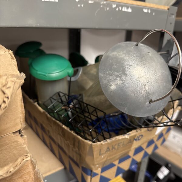 Lot of vintage garden bird feeders, including metal and plastic designs.