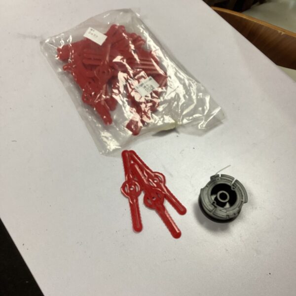 Bag of replacement strimmer blades and cord for garden maintenance.