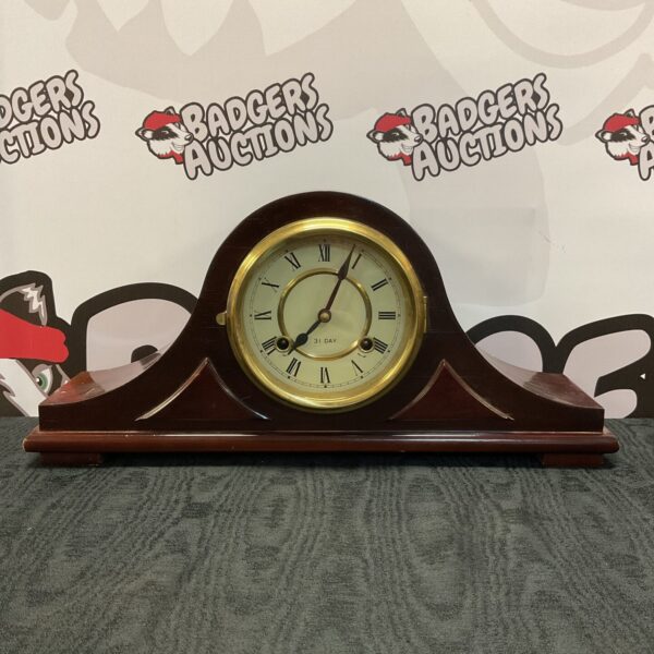 Vintage Daejin Napoleon mantle clock with wooden hat design.