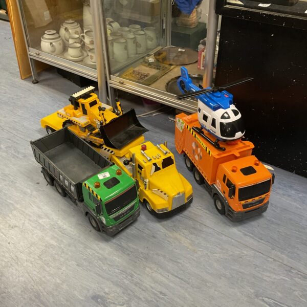 Colourful toy lorries and helicopter set for imaginative play.