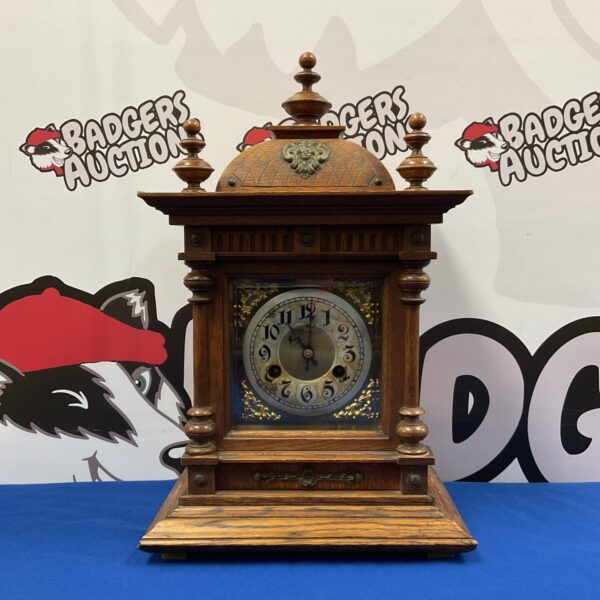 Front view of antique German bracket clock with oak case.