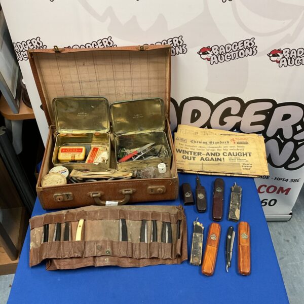 Vintage leather case containing a collection of antique cut throat razors.