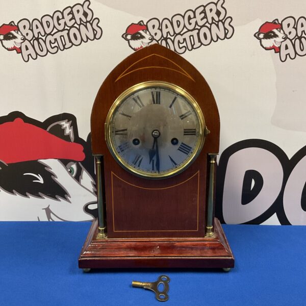 Front view of antique Edwardian mahogany mantle clock with key.