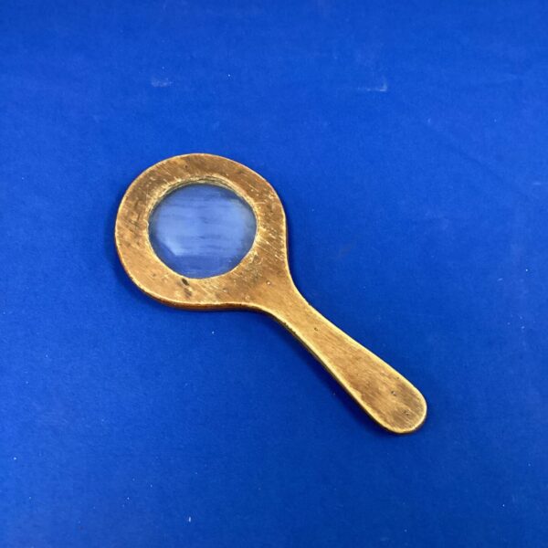 Vintage wood framed magnifying glass for reading and detailed examination.
