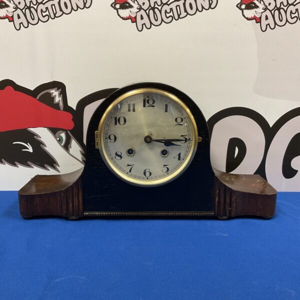 Front view of a vintage German mantle clock with a cream dial.