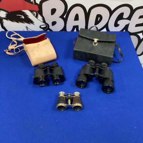 Vintage binoculars with a worn leather case, antique optical instrument.