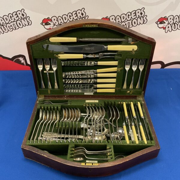 Open antique silver plate cutlery set in wooden case.