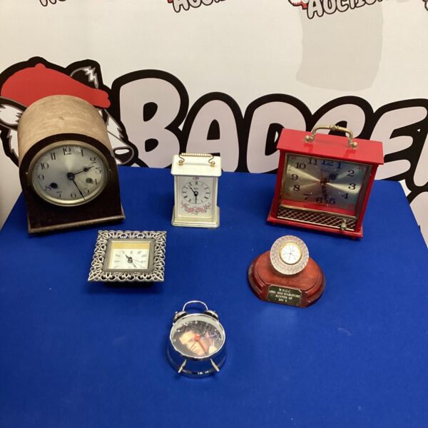 Vintage clock selection lot with various styles and designs.