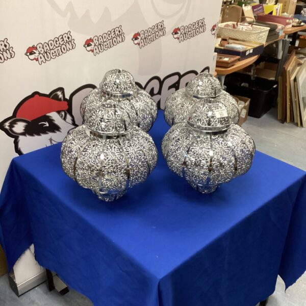 Set of four vintage Moroccan lamp shades with intricate pierced metal designs.