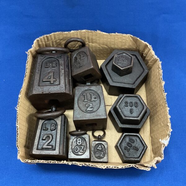 Vintage cast iron weights in pounds and kilograms for scales.