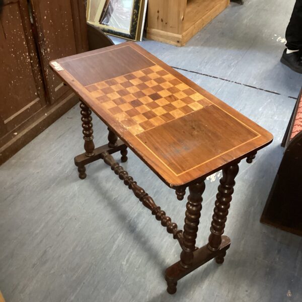 Vintage chess table with inlaid chessboard and turned legs.