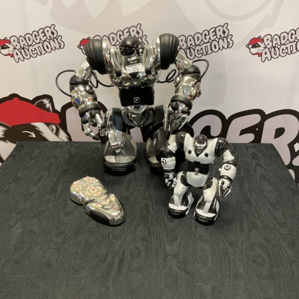 Silver vintage robot toys with remote control, collectible retro design.