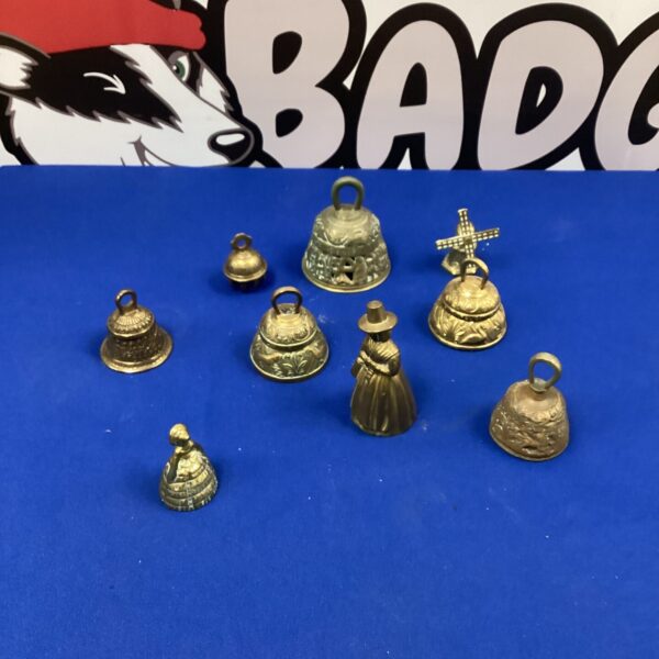 Vintage brass bell lot with varying designs and patina.