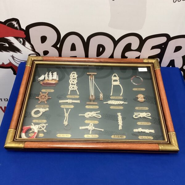 Framed nautical knot display with intricate ship knots.
