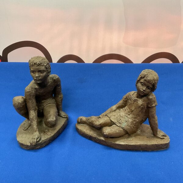 Pair of Karin Jonzen bronze resin sculptures of children.