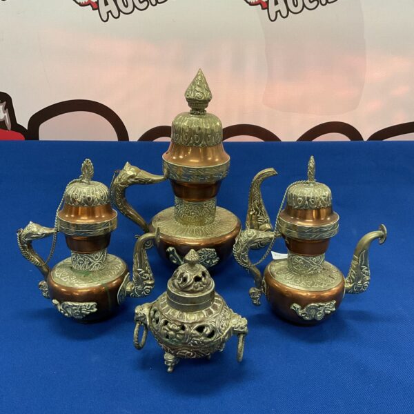 Vintage Tibetan copper coffee set with ornate teapot and cups.