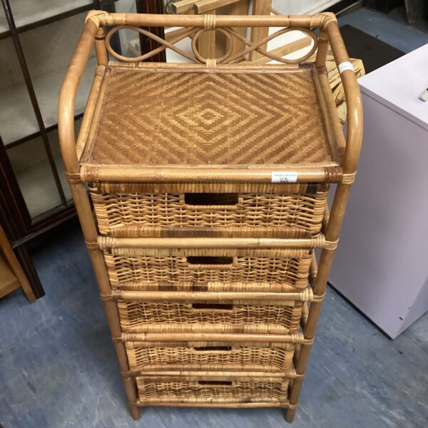 Vintage wicker drawer unit with four drawers, ideal for bedroom storage.