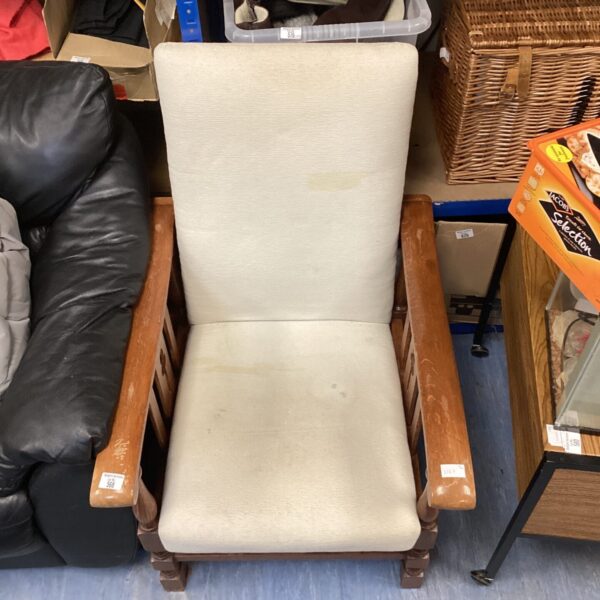 Vintage wooden armchair with faded upholstery, retro style.