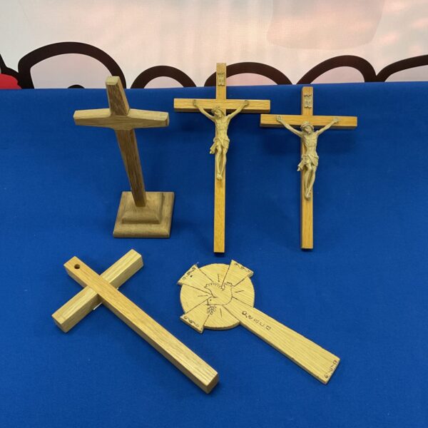 Lot of three vintage wooden crucifixes for religious display.
