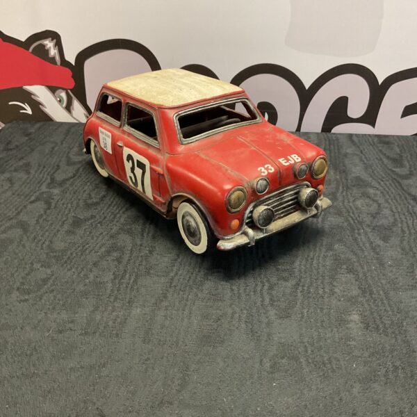 Vintage tin Mini Cooper model car, collectible toy.