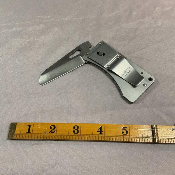 SOG Access folding knife with belt clip, showing blade and handle.