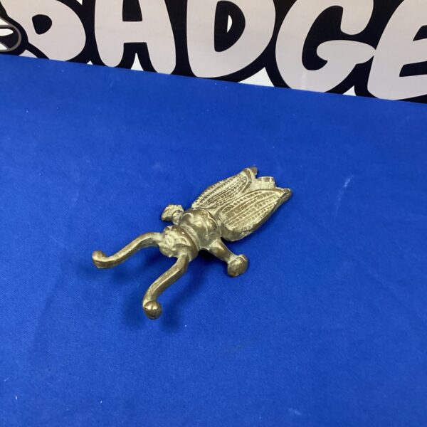 Vintage bronze boot remover with winged design.