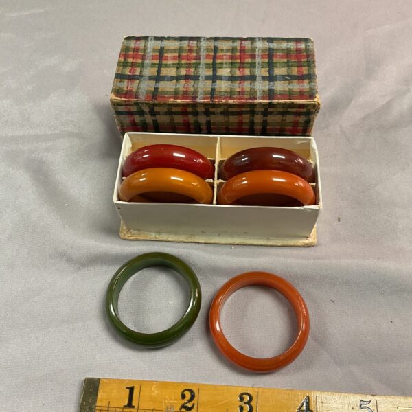 Vintage orange Bakelite napkin rings in original box.