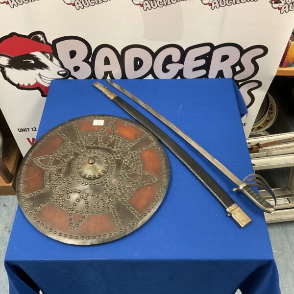 Celtic targe shield and reproduction officer’s sword on display.