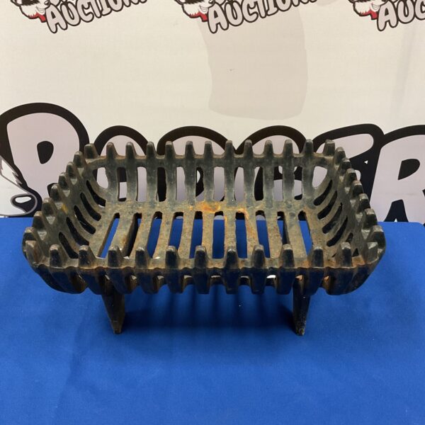 Antique cast iron fireplace basket for logs and hearth display.