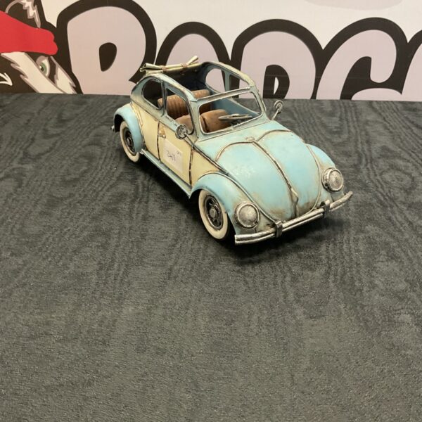 Vintage tinplate model car with blue and cream paint.