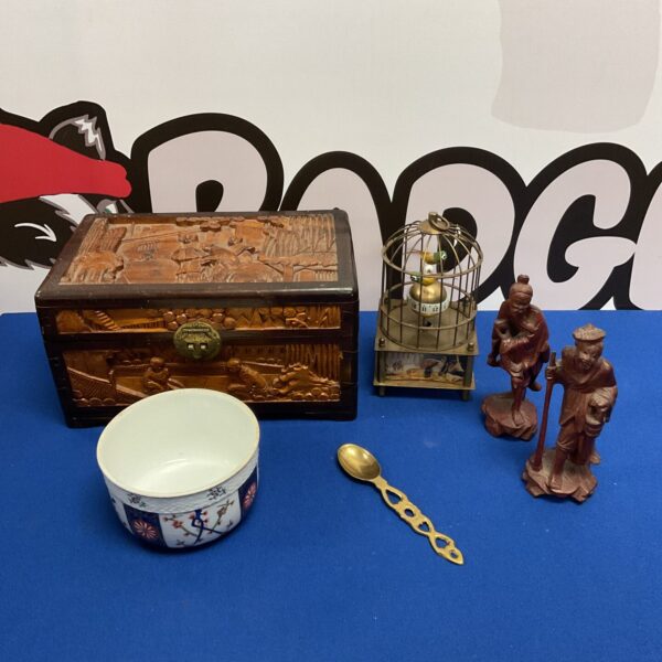 Oriental collection featuring a carved wooden box and birdcage.