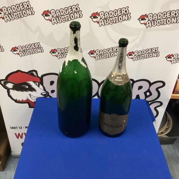 Two large empty Champagne bottles for display or decor.