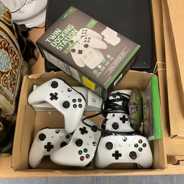 Tray of multiple Xbox wireless gaming controllers.