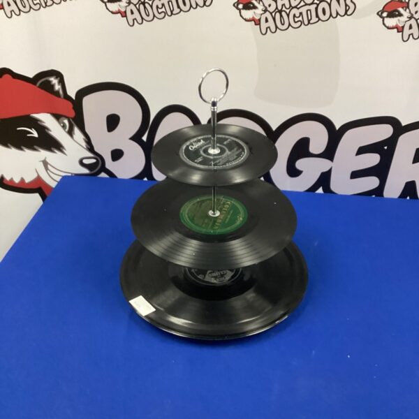 Vintage three-tiered record cake stand for display.