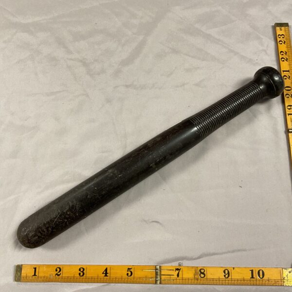 Vintage wooden police truncheon, a classic law enforcement tool.