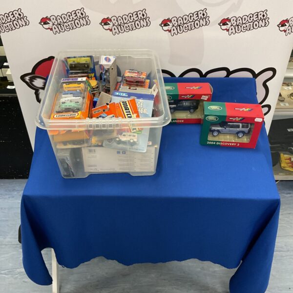 Boxed diecast model cars including Land Rover, Matchbox and Hot Wheels.