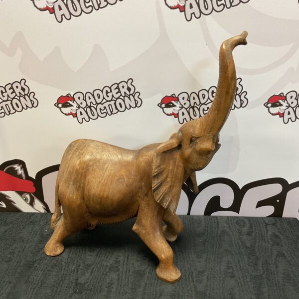 Large carved wooden elephant sculpture, detailed animal carving.