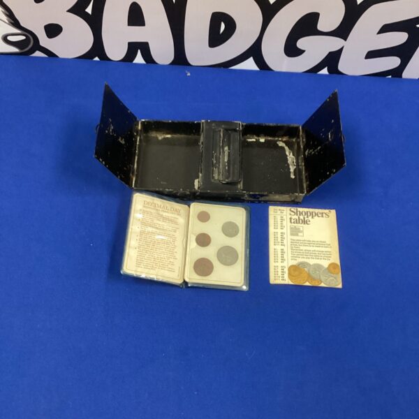 Vintage British decimal coin collection in folder and money box.