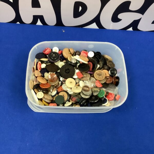 Assorted vintage buttons in a plastic tub, colourful button lot.