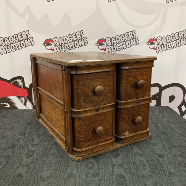 Vintage Singer sewing machine drawers for storage.