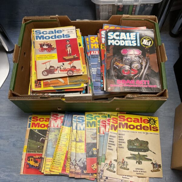 Tray of vintage scale model magazines for collectors.