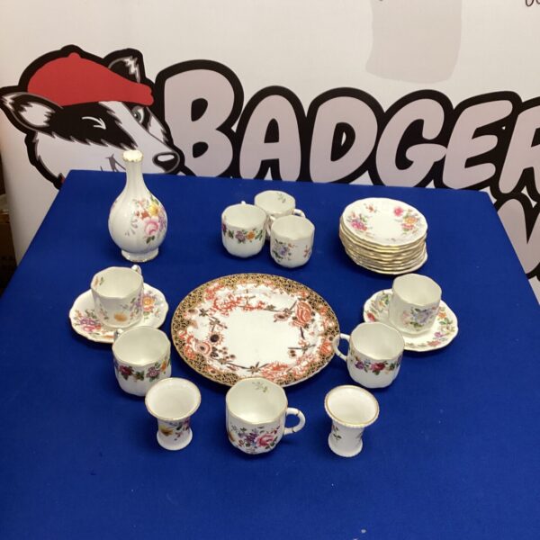 Vintage Royal Crown Derby tea cups and saucers with floral design.